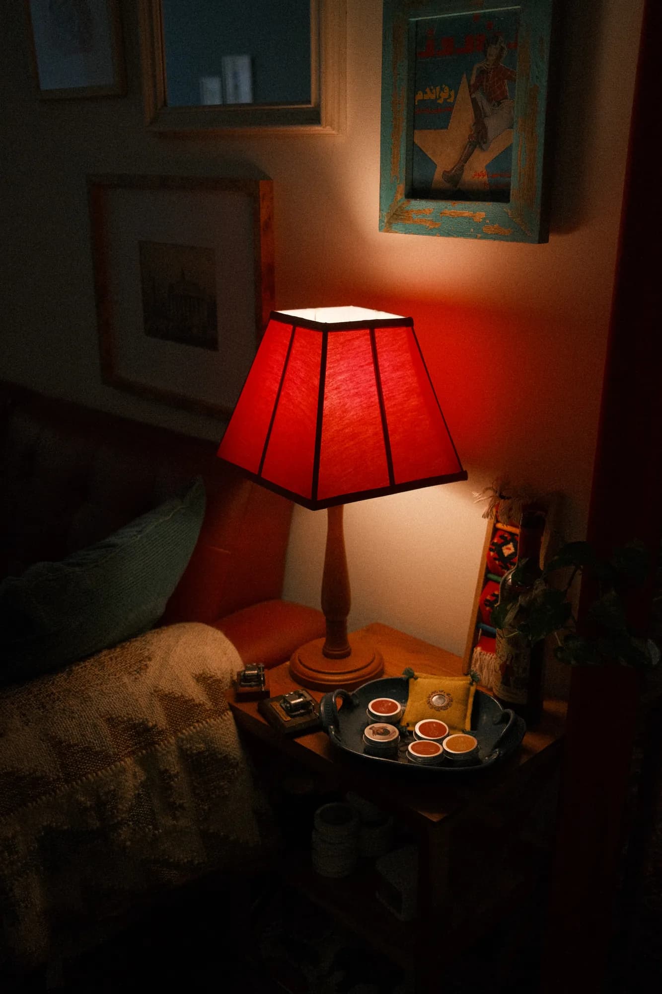 A red lamp glowing in a dark corner of the café